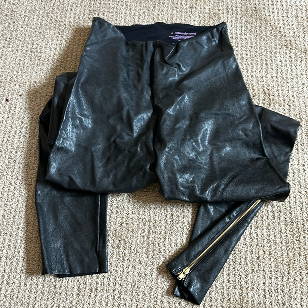 Faux leather leggings with gold zipper detail